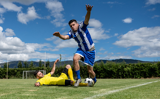 Soccer player making a foul on the field - competitive sports concepts