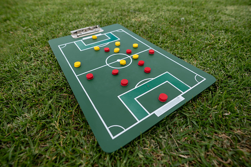 Close-up on a strategy board with the line up at a soccer field - sports concepts