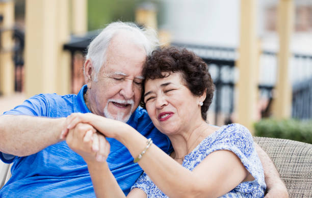 istock Senior Hispanic couple sitting outdoors head on shoulder 1128242120