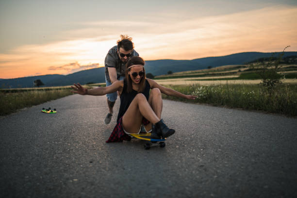 istock Couple having fun with skateboard together 1128242503