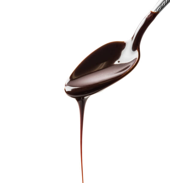 istock Hot chocolate dripping from a metal spoon 1128242658