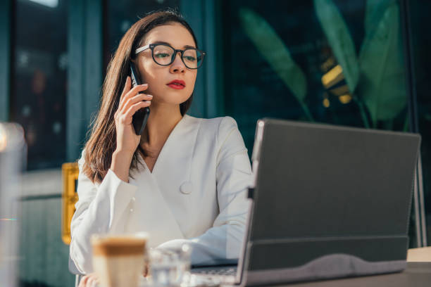 istock Elegant woman is talking on mobile phone 1128244535