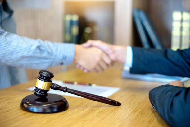 istock Justice lawyers Handshake to businessman or client 1128245567