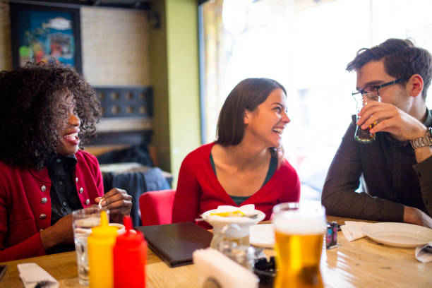 istock Friends Enjoying In Restaurant 1128245908