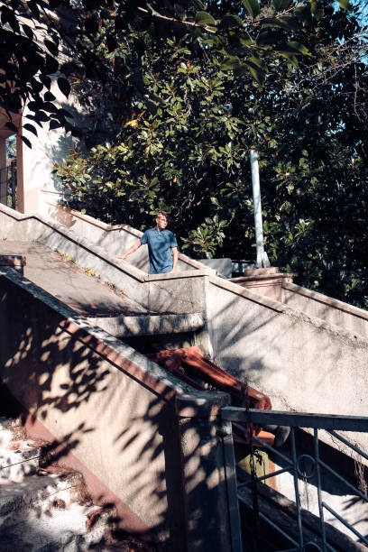 istock Old, abandoned funicular.  A young man, a stalker goes down, climbs through abandoned places. 1128246420