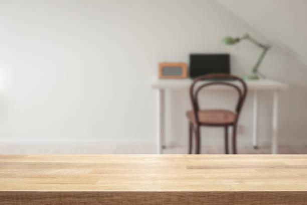 istock Empty table with modern retro home office interior blurred in the background. 1128247510