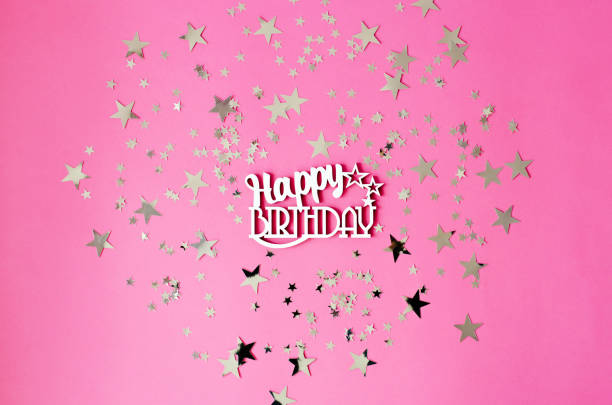 Birthday flat on a pink background with glittering stars.