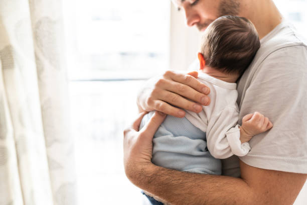You are my biggest achievment Affectionate love between father and newborn baby, father holding his son in arms in apartment newborn stock pictures, royalty-free photos & images