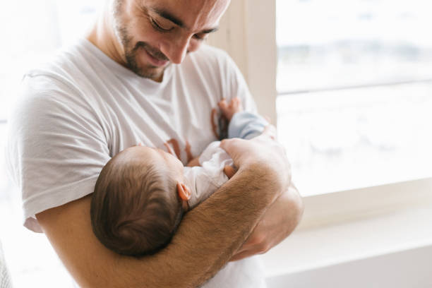 istock New dad holding baby 1128249098