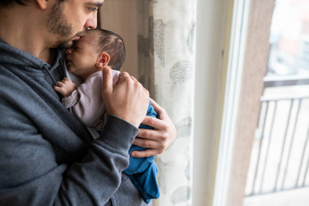 istock Father kissing newborn son 1128249109