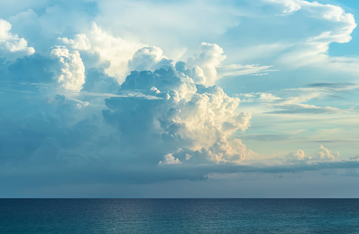 Incoming thunderstorm forming over ocean at sunset. Panhandle in Florida.