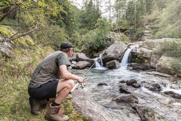 istock Fishing adventures. Fisherman on a mountain stream 1128251238