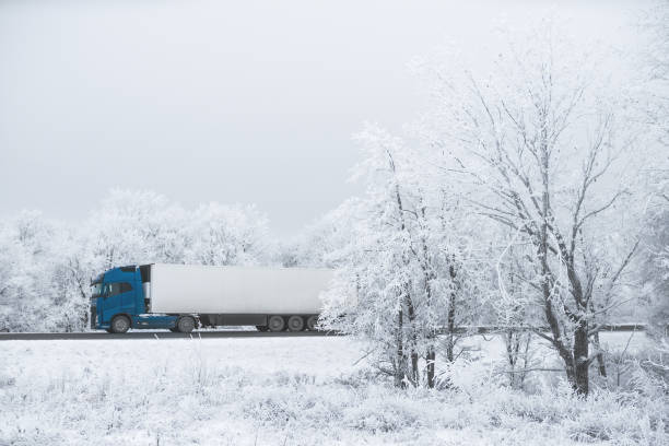 truck goes on winter road to blizzard
