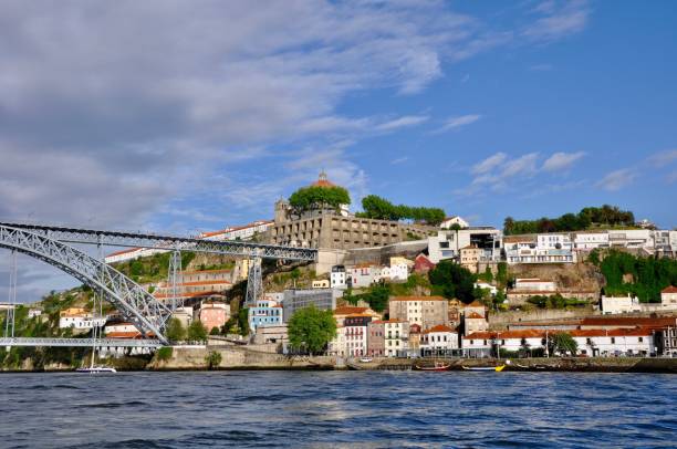 istock Arch Bridge Over River Against Buildings In City 1128253871