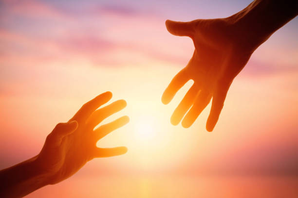 Giving a helping hand on the background of the dawn Giving a helping hand on the background of the dawn. Social life disabled person hiking outdoors stock pictures, royalty-free photos & images