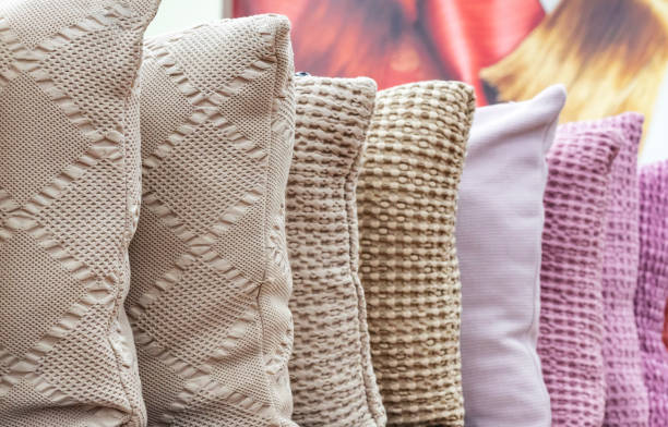 istock Knitted decorative pillows in different colors on the shop counter. 1128255302