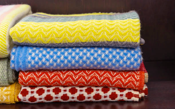istock Woolen plaids on the shelf in the store. 1128255388