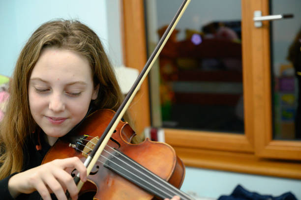 istock Girl playing violin 1128255820