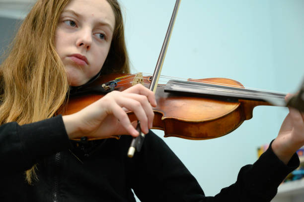istock Girl playing violin 1128255930