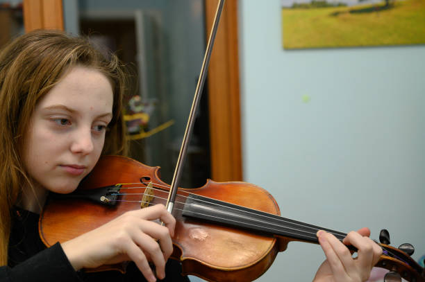 istock Girl playing violin 1128256633