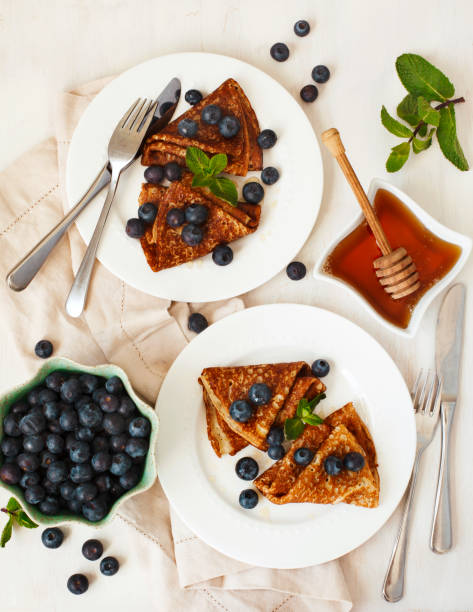 istock Homemade crepes with fresh blueberries and honey 1128257242