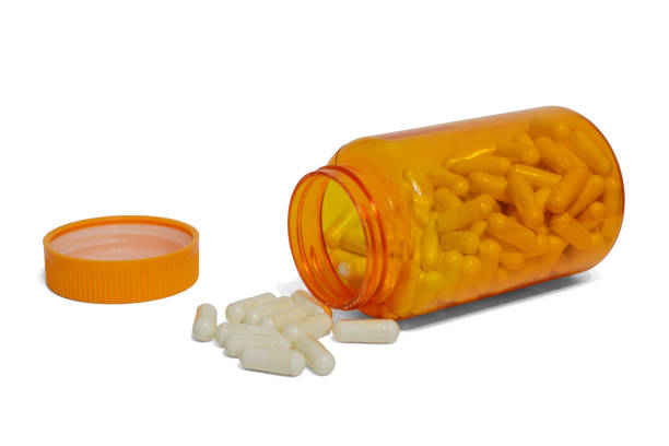 istock scattered pills from an orange jar and a cover on a white background 1128258858