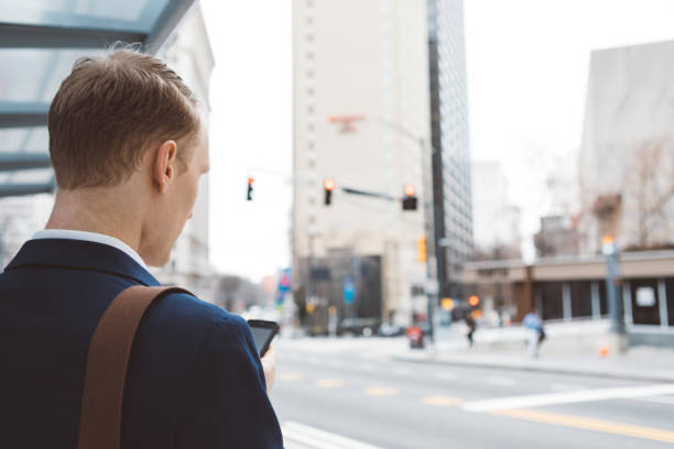 istock man using a smart phone out in the city 1128260508