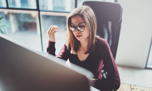 istock Attractive young businesswoman using desktop computer at modern working place at office.Blurred background.Horizontal. 1128264178