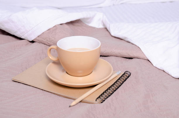 istock Cup of coffee witrh saucer notepad pencil 1128264252