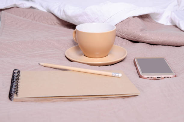 istock Cup of coffee with saucer notepad pencil smartphone 1128264282