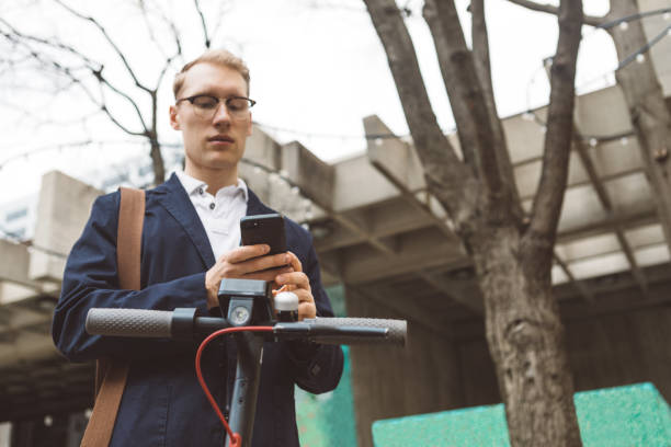 young man about to use a shared electric scooter