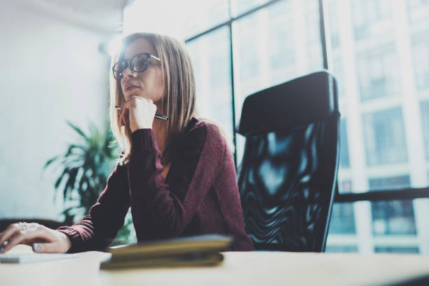 istock Attractive young businesswoman using desktop computer at modern working place at office.Blurred background.Horizontal. 1128265196