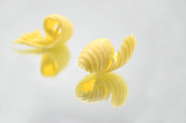 Roll of butter on an isolated background. Picture is ideal for advertising all kinds of dairy products