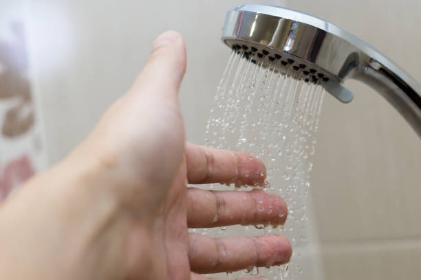 istock hand in the shower test water temperature 1128273983