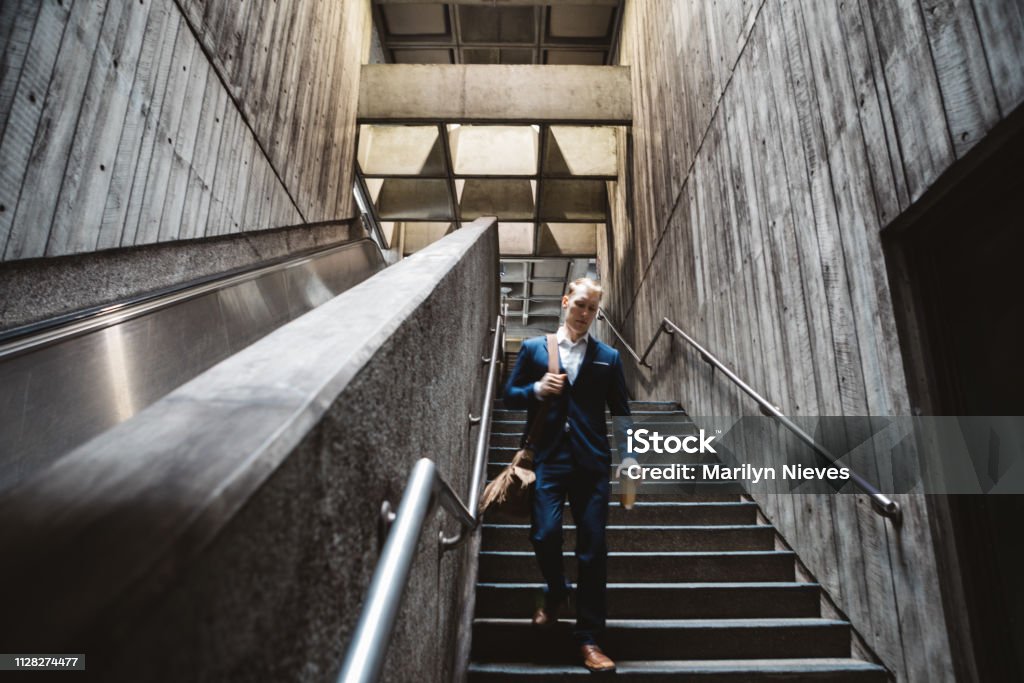 businessman commuting business commuter walking down the steps to take the train Adult Stock Photo