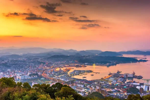 Sasebo, Nagasaki, Japan downtown city skyline on the bay at dawn.