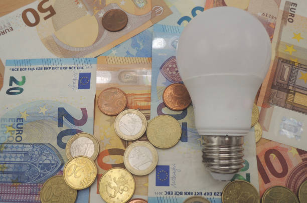 istock Euro money, banknotes and coins with a lamp on a table. 1128275170