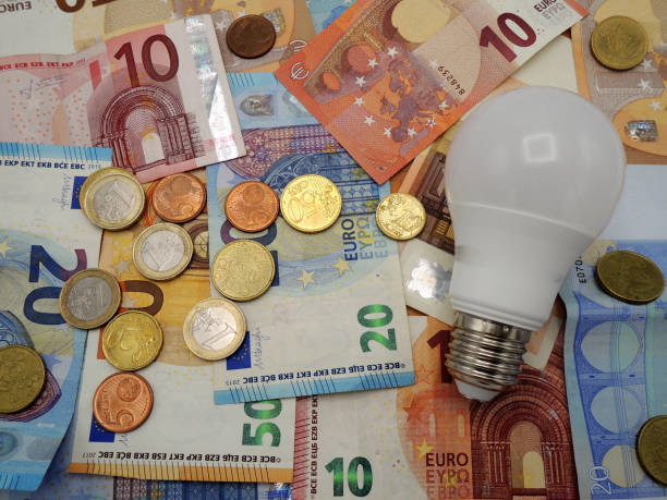 istock Euro money, banknotes and coins with a lamp on a table. 1128275173