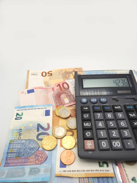 istock Euro money, banknotes and coins with calculator on a table. 1128275233