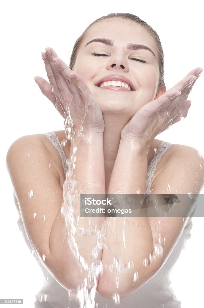 Close-up of beautiful woman washing her face Close-up portrait of beautiful emotional woman washing her face - isolated on white Adult Stock Photo