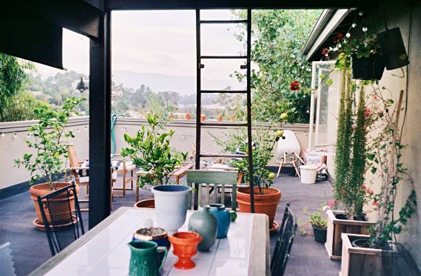 istock Patio with tables chairs and flower vases 1128278314