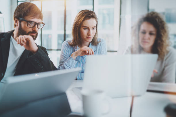 istock Business meeting concept.Coworkers team working with mobile computer at modern office.Blurred background.Horizontal. 1128280212