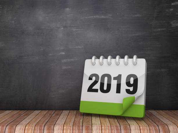 istock 2019 Calendar on Wood Floor - Chalkboard Background - 3D Rendering 1128280307