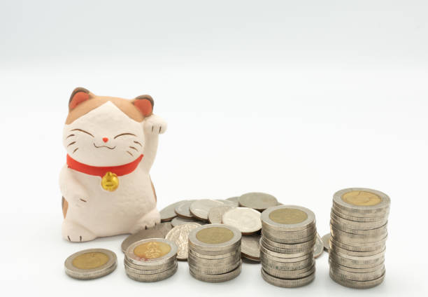 istock Japanese fortune wealth cat figure ( Maneki Neko) with stacking coins 1128280965
