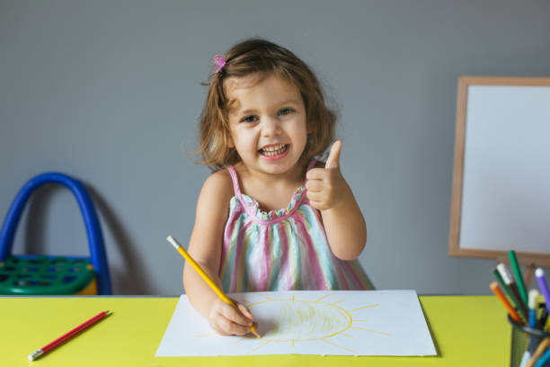 istock little girl drawing 1128283636