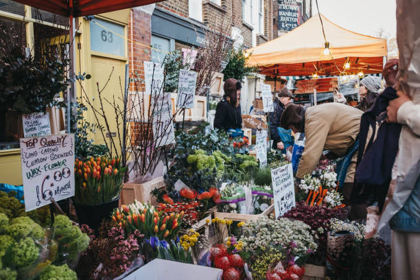People buying flowers at Columbia Road Flower Market, London, UK. London, UK - February 3, 2019: People buying flowers from a market stalls at Columbia Road Flower Market, a street market in East London that is open every Sunday. flower market stock pictures, royalty-free photos & images