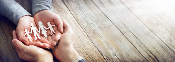 Family Care - Hands With Paper Silhouette On Table