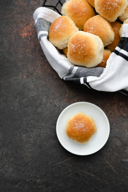istock Homemade Dinner Rolls in Wire Basket; One Isolated on White Plate 1128291513