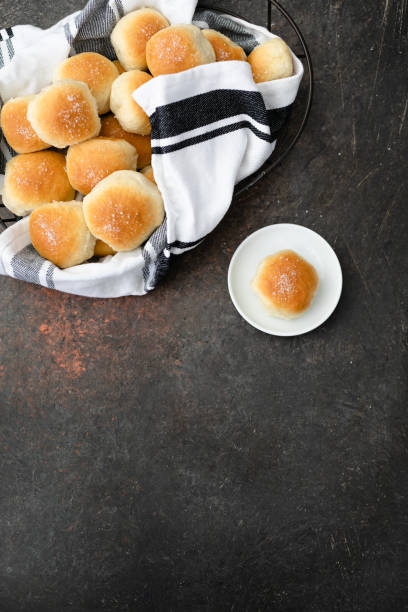 istock Homemade Dinner Rolls in Wire Basket; One Isolated on White Plate 1128292644