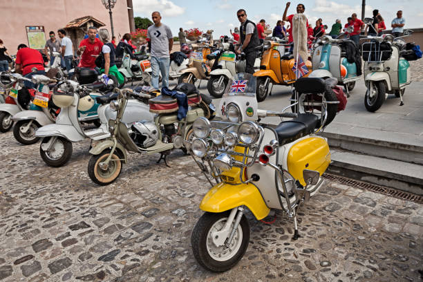 vintage italian scooter customized in British mod style with much headlights, rearview mirrors and horns in meeting Innocenti Day of Lambretta club Umbria, on June 14, 2014 in Bertinoro, FC, Emilia-Romagna, Italy